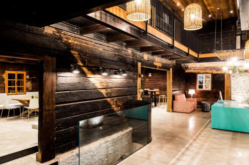 a lobby with wooden walls and a table and chairs at Peakini Farmhaus in Untertauern