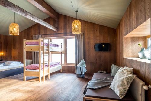 a room with a bunk bed and a couch at Peakini Farmhaus in Untertauern