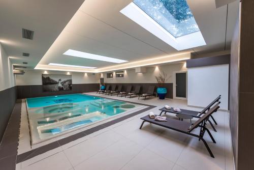 a swimming pool with a skylight in a house at Villa Italia Luxury Suites and Apartments in Arco