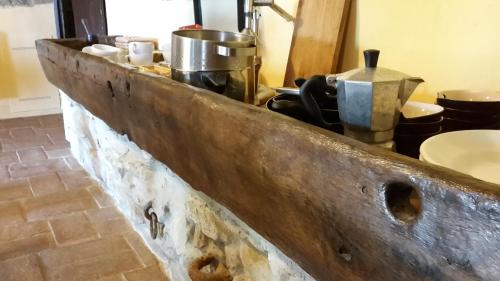 a kitchen with a wooden counter with pots and pans at Bioagriturismo Poderaccio in Incisa in Valdarno