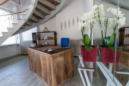 a room with two vases with white flowers in them at Boulevard 900 in Revello