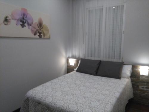 a bedroom with a bed and flowers on the wall at Valencia-Ruzafa Studio in Valencia