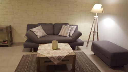 a living room with a couch and a coffee table at Grüner Wald in Burg Kauper