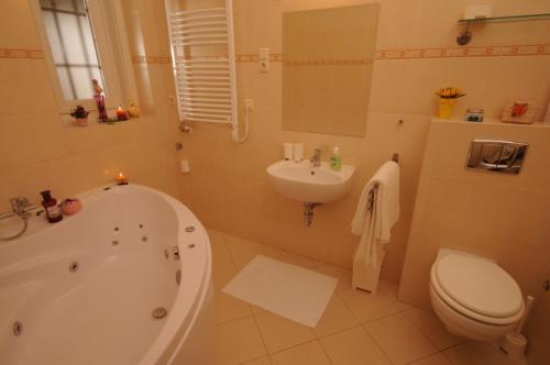 a bathroom with a tub and a toilet and a sink at Budapest Museum Central in Budapest