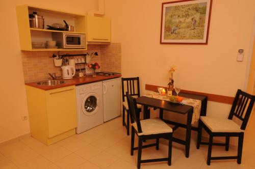 a kitchen with a table and chairs and a washing machine at Budapest Museum Central in Budapest