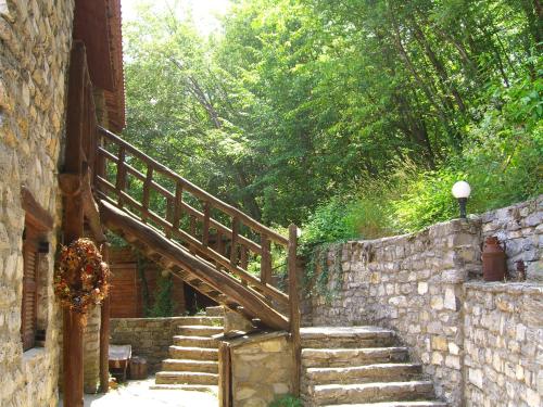 a wooden staircase leading up to a stone wall at Arxontiko Agonari in Metamorfosi