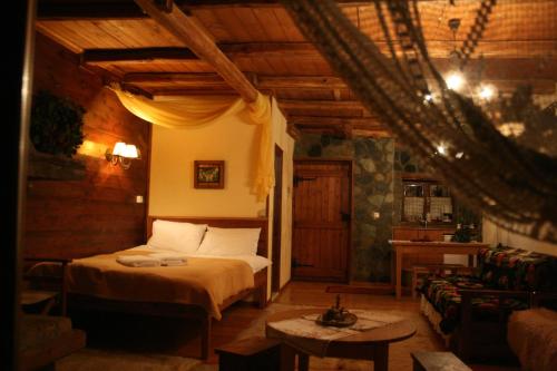 a bedroom with a bed and a couch at Arxontiko Agonari in Metamorfosi