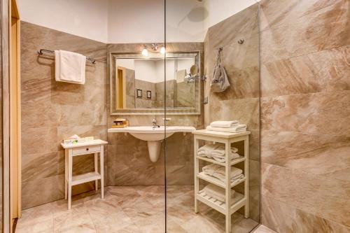 a bathroom with a sink and a shower at Pushka INN hotel in Saint Petersburg