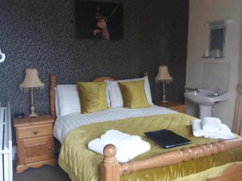 a bedroom with a bed with towels on it at New Hall Bank in Bowness-on-Windermere