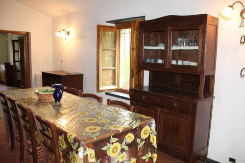 a dining room with a table and a china cabinet at Fontanacota in Imperia