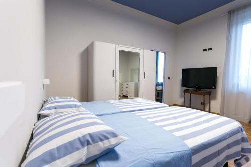 a bedroom with two beds and a television in it at Boulevard 900 in Revello