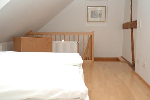 a bedroom with a bed and a wooden floor at Altstadt Apartment in Bamberg