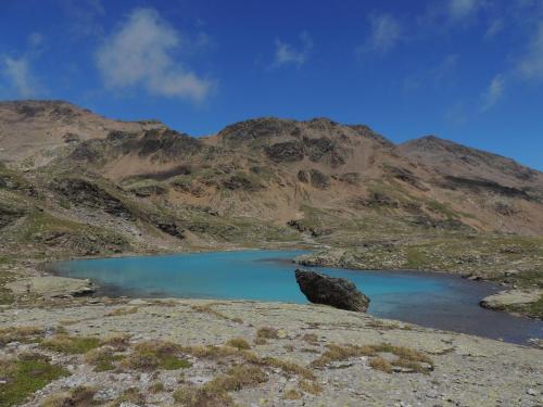 a blue lake in the middle of a mountain at Appartamenti Pirovano Bormio in Bormio