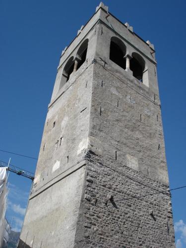 a tall tower with two bells on top of it at Appartamenti Pirovano Bormio in Bormio