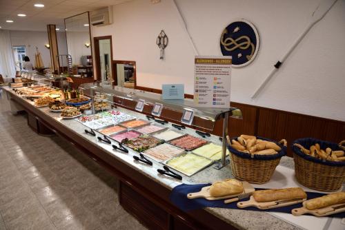 a buffet line with different types of sandwiches and pastries at Hotel Internacional in Calella