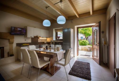 a kitchen and dining room with a table and chairs at Archanes Residences in Archanes