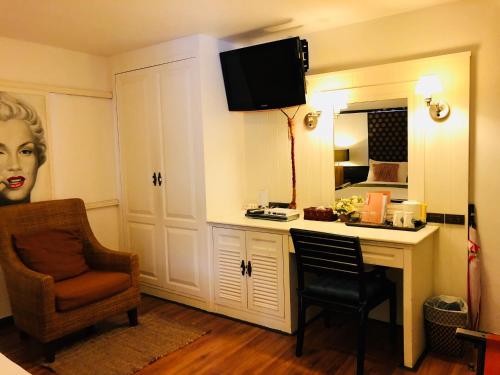a room with a desk with a chair and a mirror at Baipho Lifestyle in Patong Beach