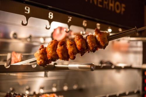 a bunch of skewers of food cooking in an oven at Mettner Hof in Metten