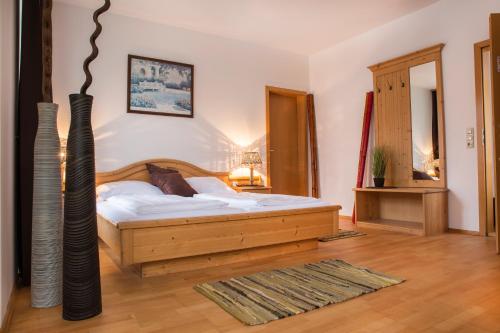 a bedroom with a bed and a vase at Mettner Hof in Metten