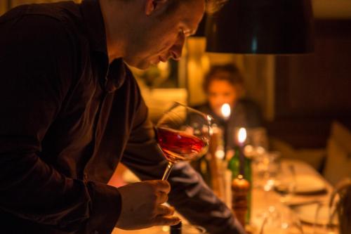 a man is holding a glass of wine at Mettner Hof in Metten
