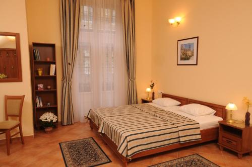 a bedroom with a bed and a window at Budapest Museum Central in Budapest