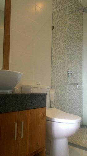 a bathroom with a white toilet and a sink at ThreeWin Homestay in Ubud