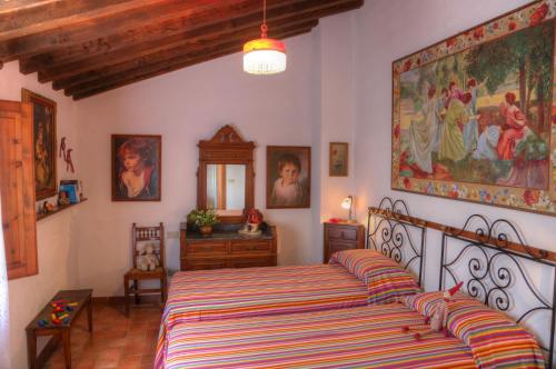una camera da letto con un letto e un dipinto sul muro di La Casa Di Nonna Lucia a Montescudaio