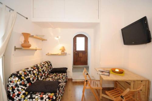 a living room with a couch and a table at Romantic getaway in the heart of Amalfi in Amalfi