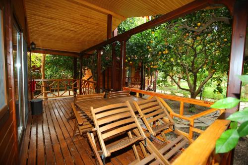 a porch with rocking chairs on a house at Bahçe Villa in Cıralı