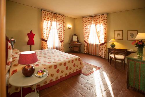 a bedroom with a bed and a table with a lamp at Villa Tiboldi in Canale