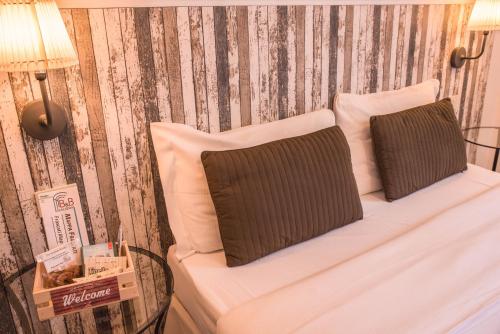 a white bed with two pillows and a lamp at Galleria Frascati Rooms and Apartment in Frascati