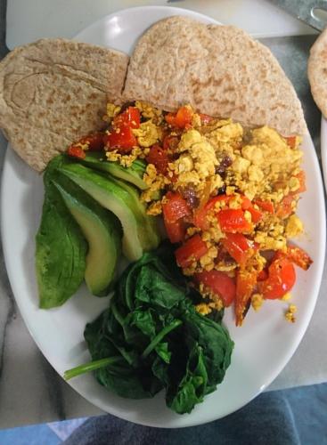a plate of food with eggs and vegetables and bread at Abbey Court Guest House in Carlisle