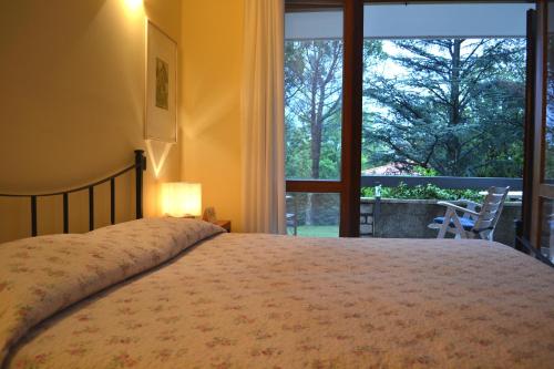 a bedroom with a bed and a large window at Villa Rilke Duino in Duino