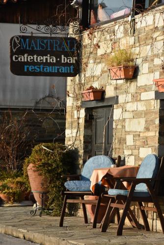 a table and chairs sitting outside of a restaurant at Maistrali Hotel in Afissos