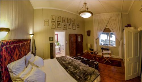 a bedroom with a bed and a room with a table at The Beachhouse in Port Nolloth