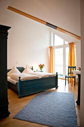 a bedroom with a bed and a large window at Hotel Wirtshaus am Schloss in Aicha vorm Wald