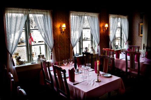 a dining room with a table with wine glasses and candles at Svostrup Kro in Silkeborg