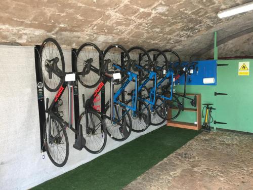 a bunch of bikes are hanging on a wall at Son Cleda, house boutique adults only in Sineu