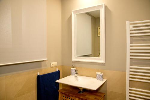a bathroom with a sink and a mirror at Elements Rooms in Toledo