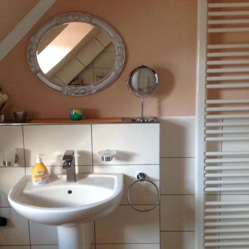 a bathroom with a sink and a mirror at Feriendomizil strasser in Homburg