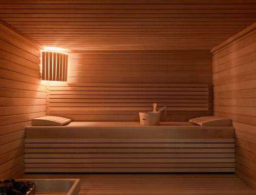 a sauna with two benches and a light on it at OKKO Hotels Bayonne Centre in Bayonne