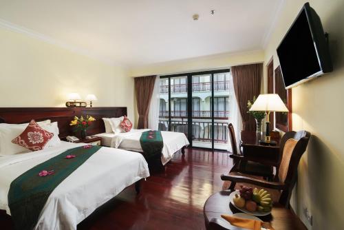 Ένα ή περισσότερα κρεβάτια σε δωμάτιο στο Smiling Deluxe Hotel