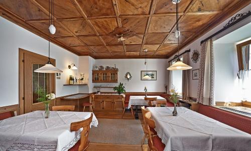 a restaurant with two tables and a dining room at Garni Pramstrahler in Chiusa