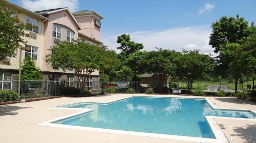 a swimming pool in front of a building at Extended Stay America Suites - Raleigh - RTP - 4919 Miami Blvd in Durham