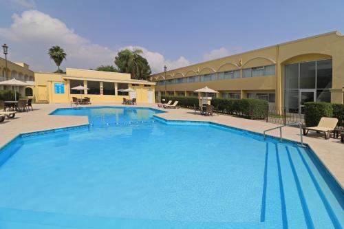 une grande piscine en face d'un bâtiment dans l'établissement Holiday Inn Monterrey Norte, an IHG Hotel, à Monterrey