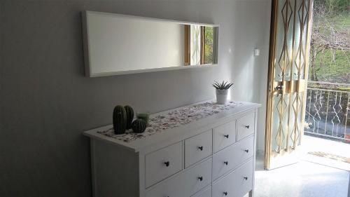 a white dresser with a mirror on top of it at Hotel Ristorante El Caracol in Mulazzo