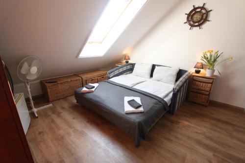 a bedroom with a large bed in a attic at Sorompó Vendégház in Balatonkenese