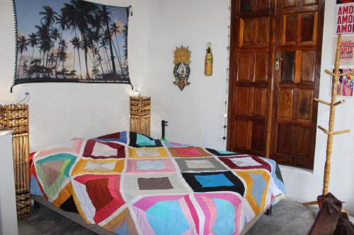 A bed or beds in a room at Camping & Hostel Flor Do Cerrado