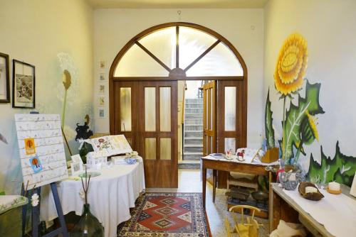 a room with a table and a large doorway at La casa di Zia Mimina in Civitella Casanova