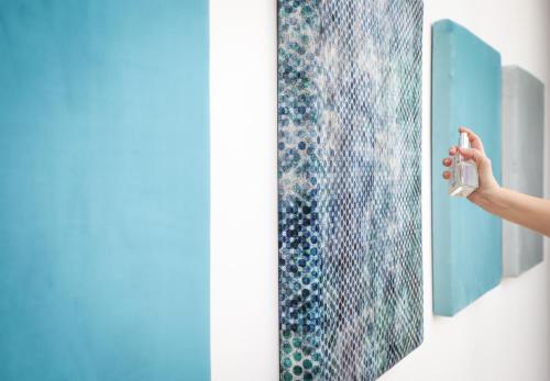 a person is looking at a painting on a wall at Palazzo Filisio - Regia Restaurant in Trani